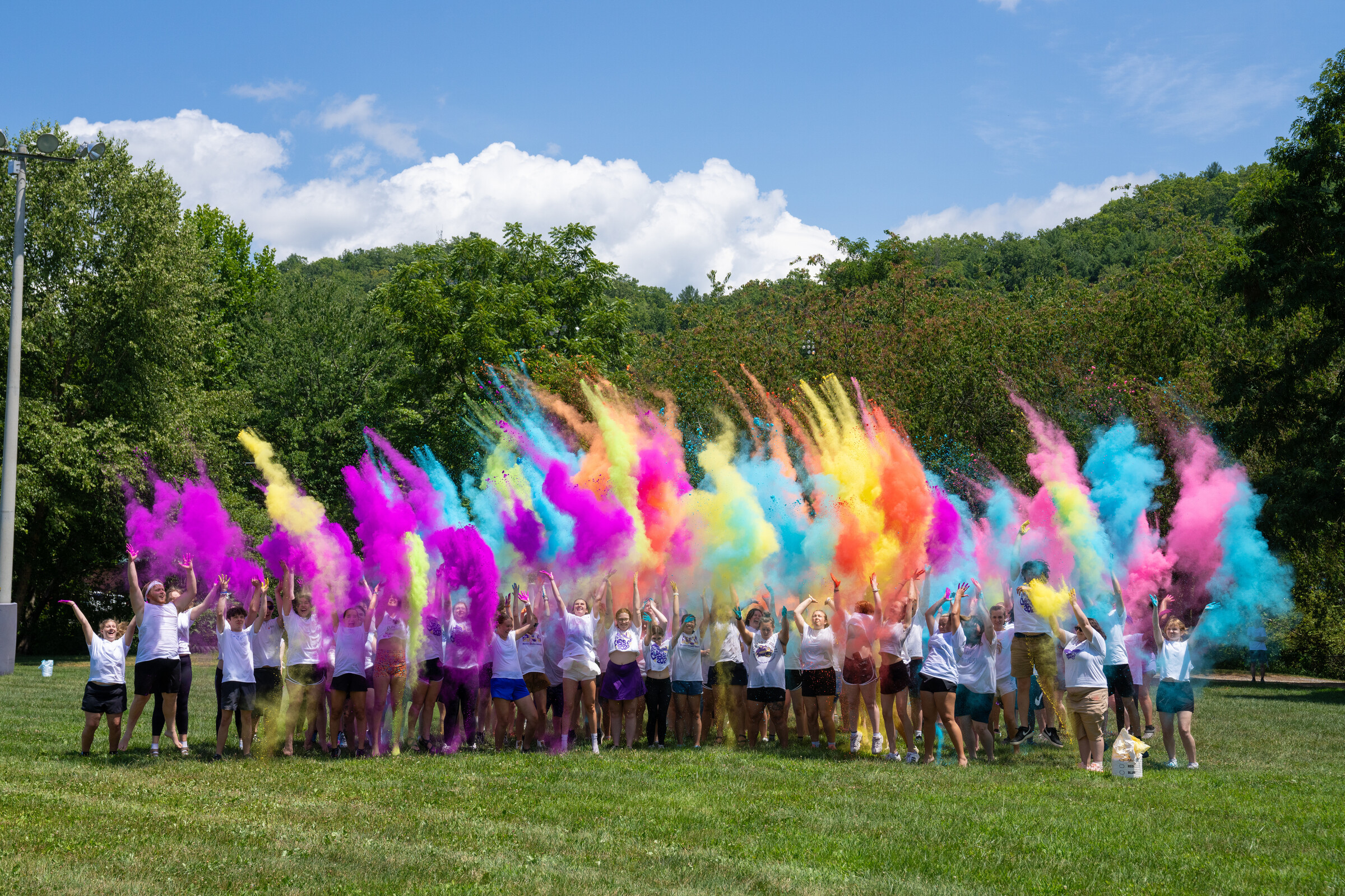 Students participate in a chalk/powder (color) throwing event