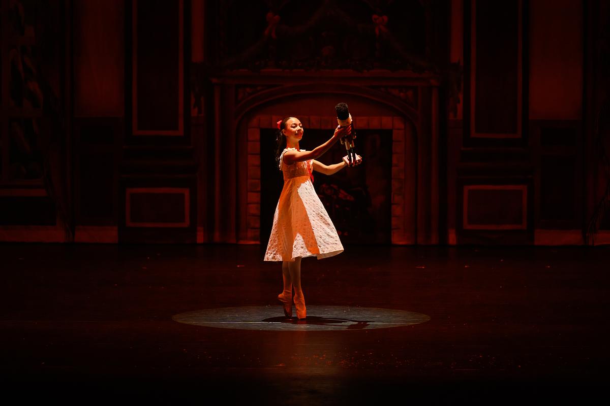 Ballerina dancing on stage during a live performance of the Nutcracker