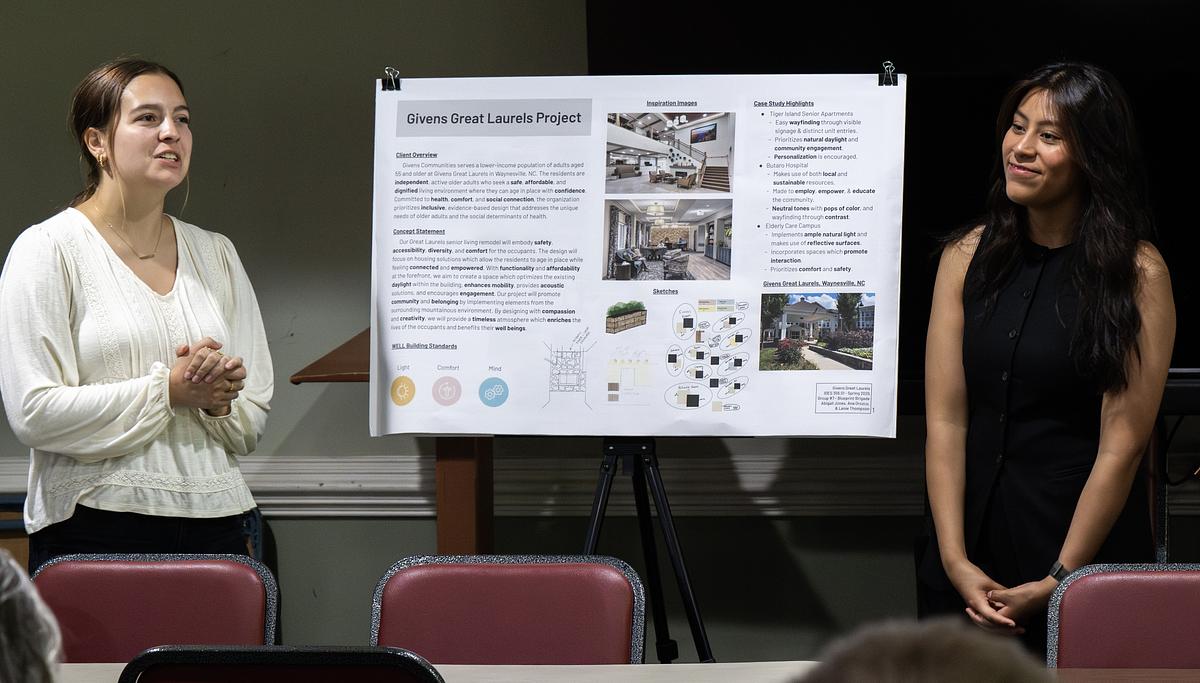 Interior design students speaking during a presentation