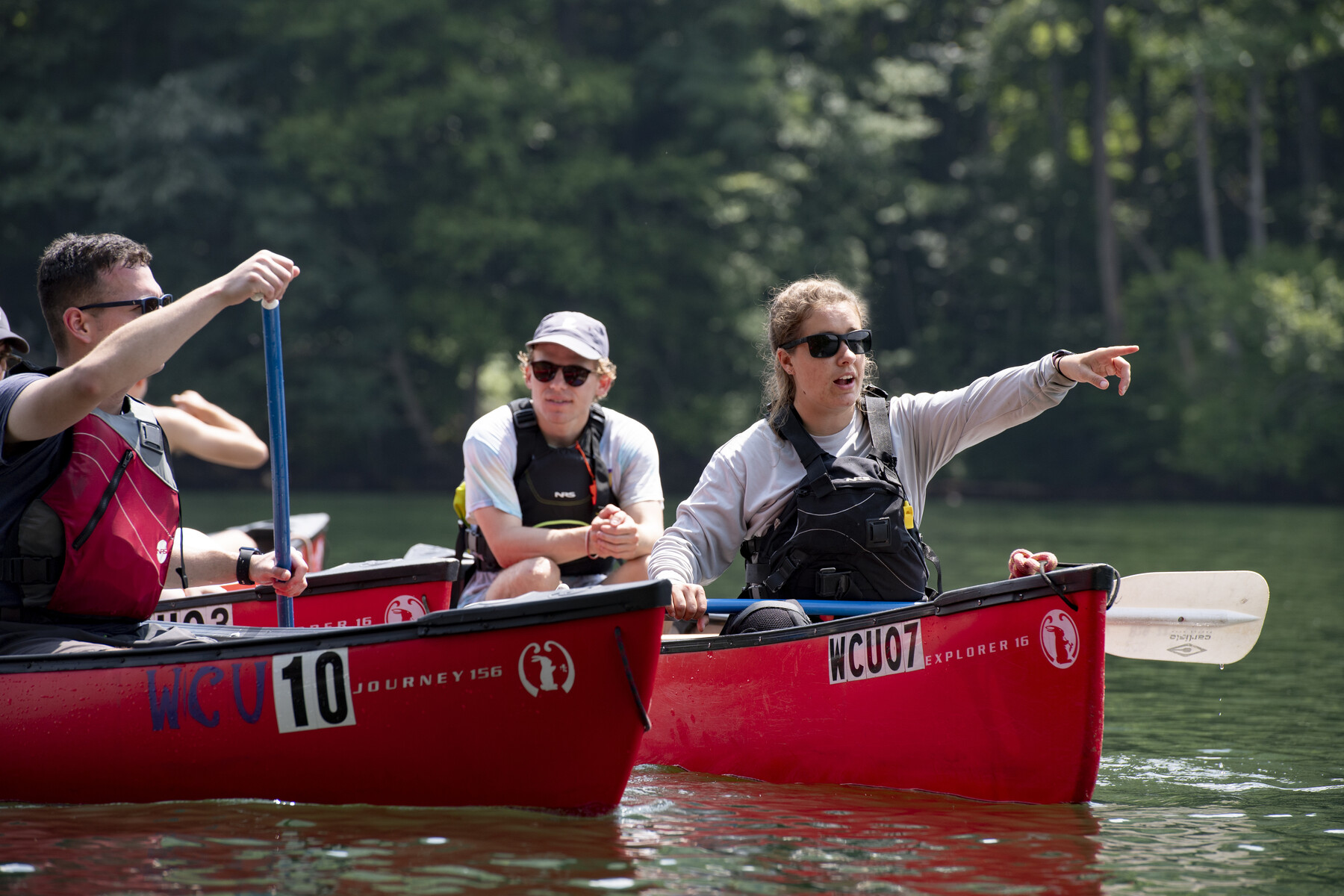 students in canoes on the lake