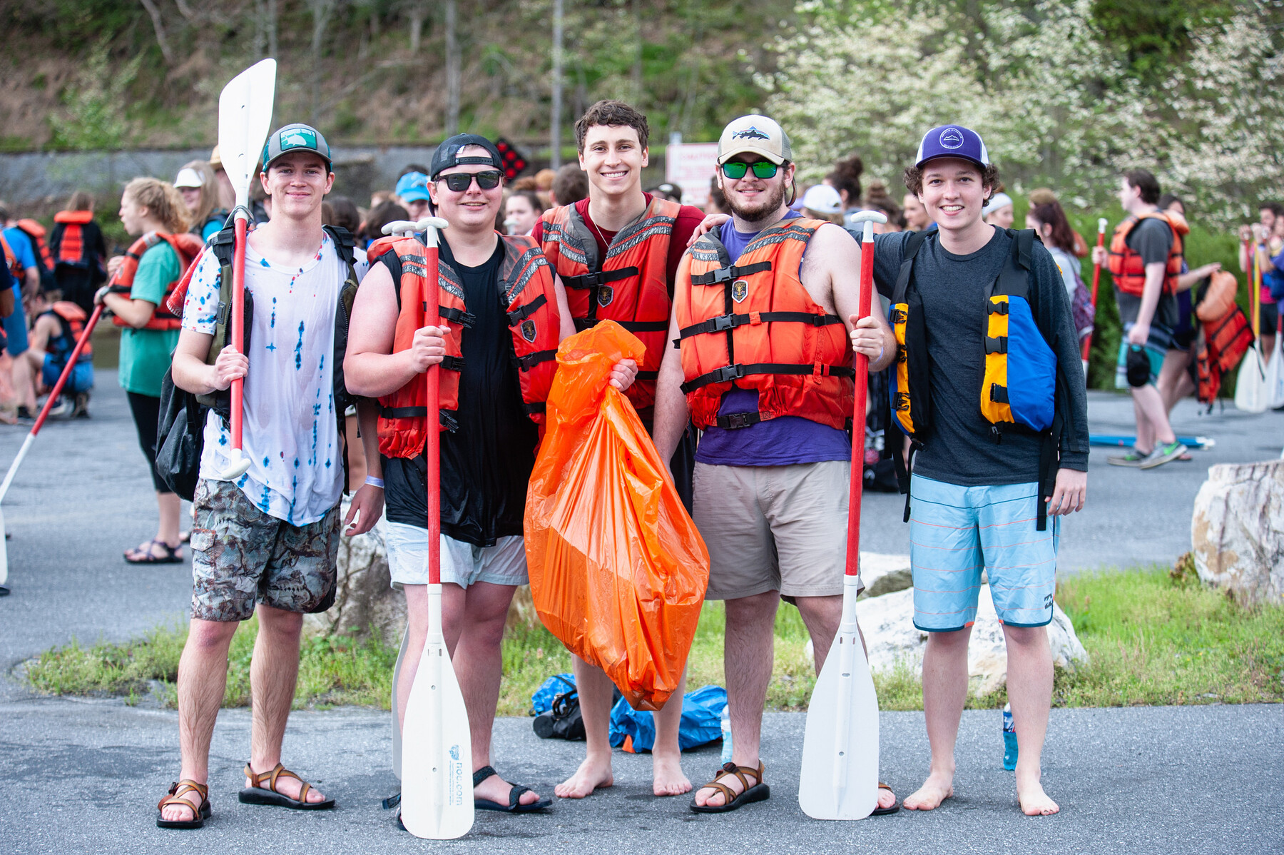 students holding trash bags