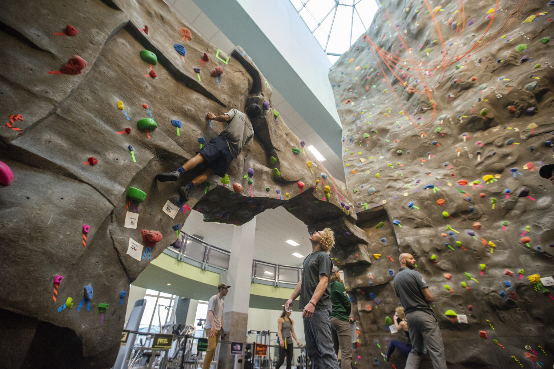 students climbing on indoor climbing wall
