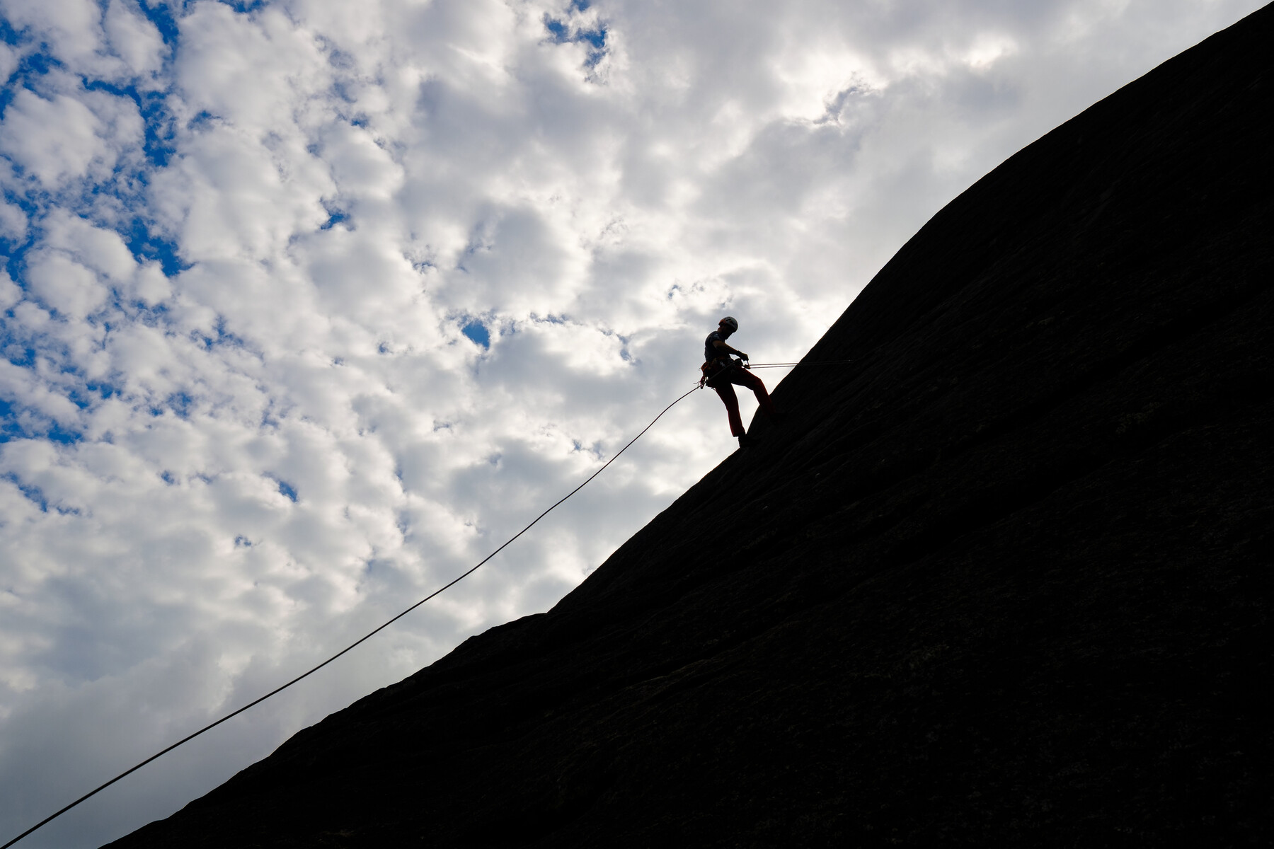 student rock climbing