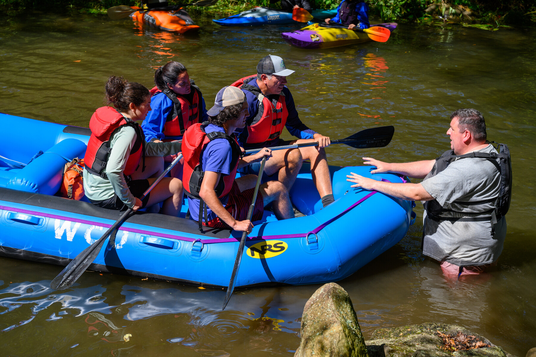 students in a river raft