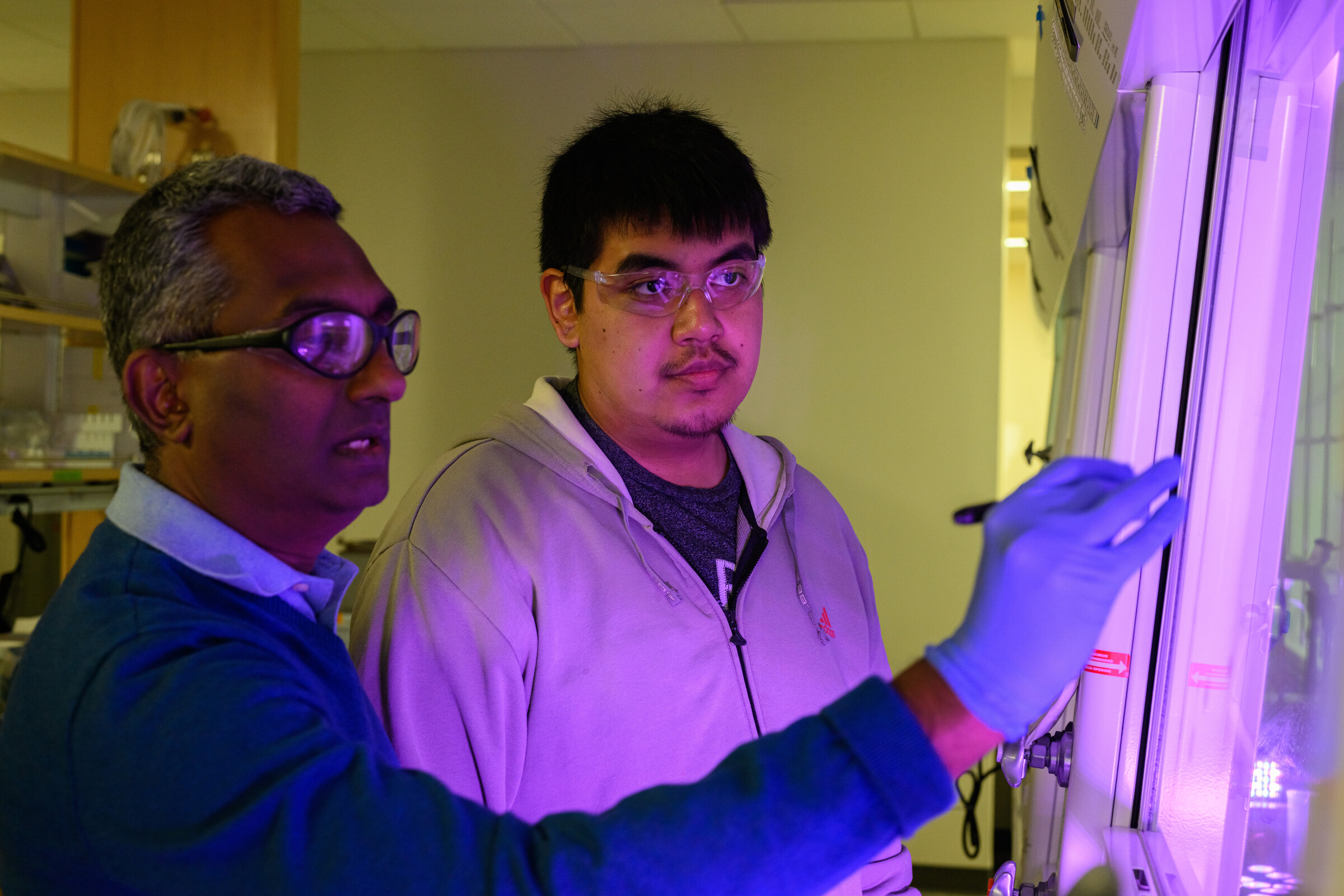 student and professor working on research