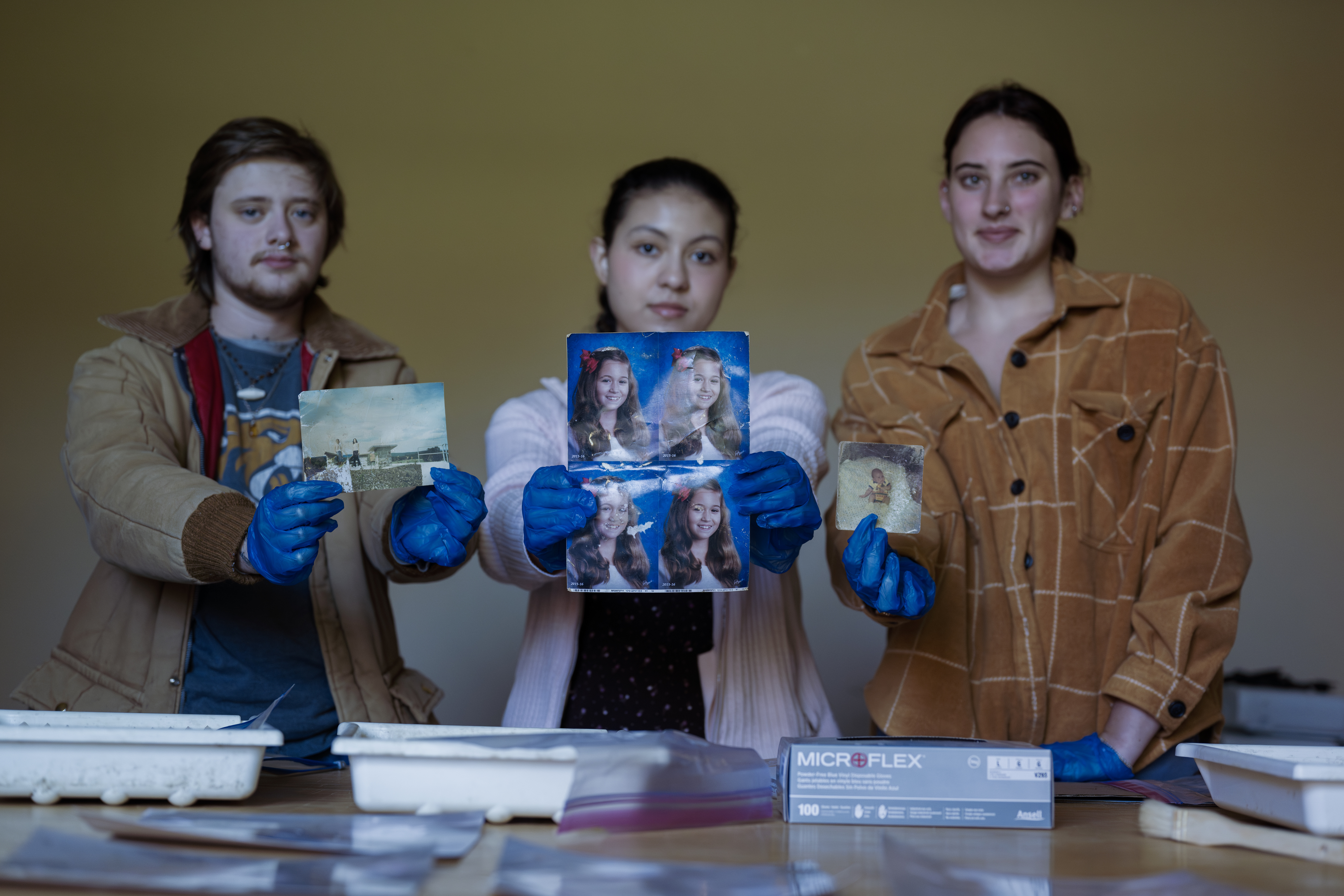 students holding photos