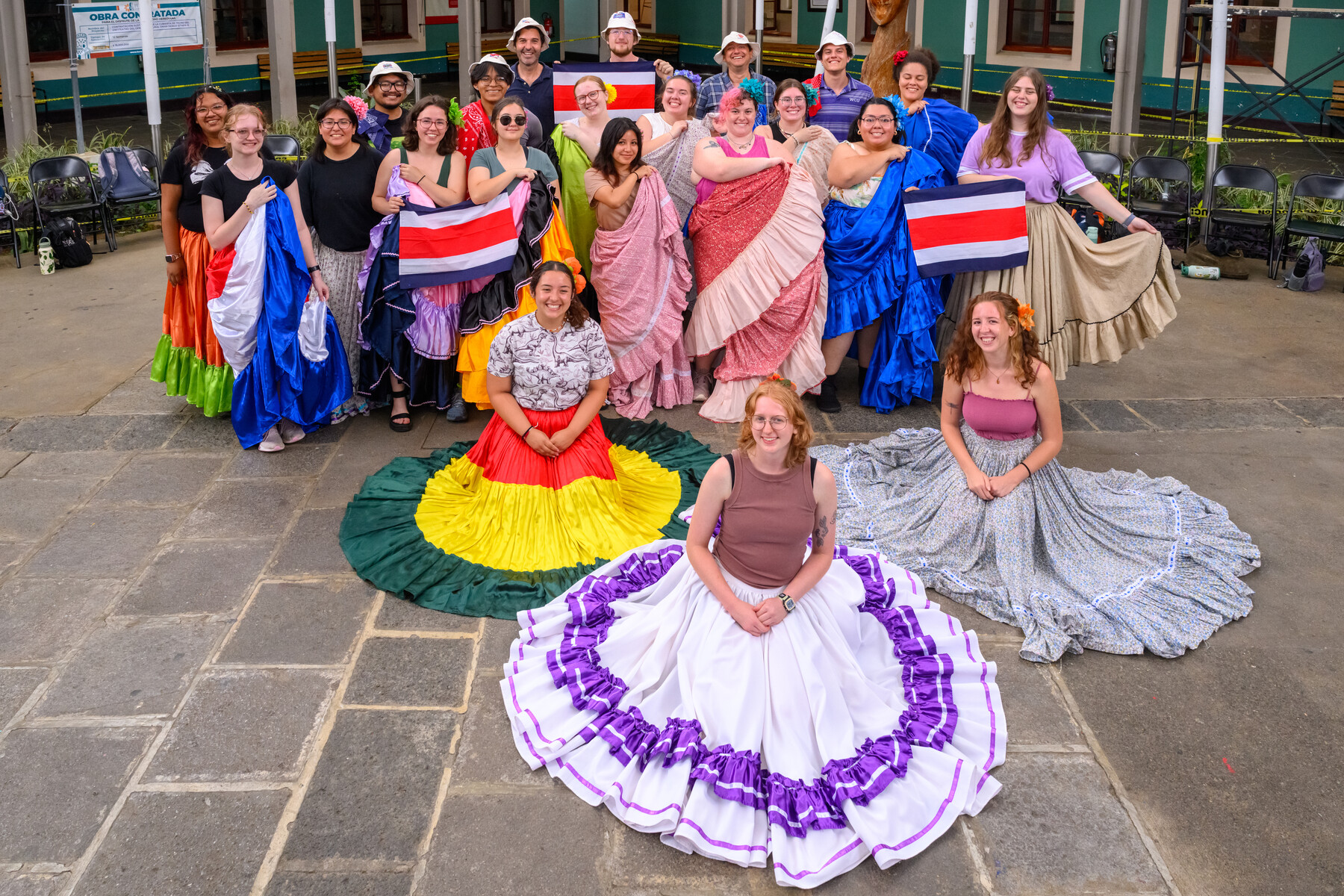 students posing for group photo in colorful attire